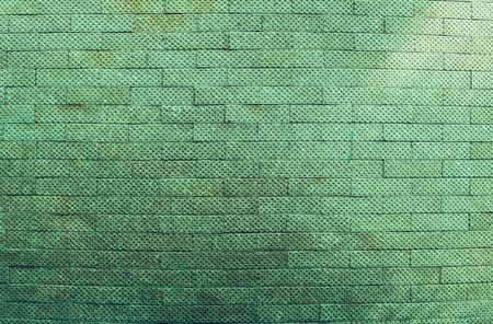 The green bricks wall background vintage and modern textureの写真素材