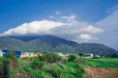 Mountain hills glowing in sunlight over highway in mountains with perfect blue sky.wonderful sunny scene.Beauty Country Road Side View and mountain background cloudsの写真素材