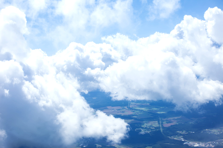 Beautiful view of cumulus clouds with sunny day atmosphere from airplain windowの写真素材