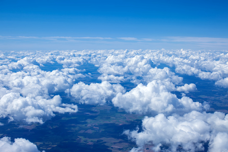 Beautiful view of cumulus clouds with sunny day atmosphere from airplane windowの写真素材