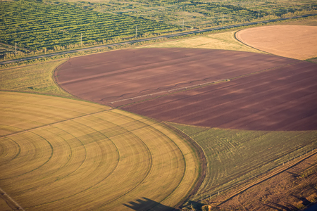Automatic sprinklering system of a cultivated field.Central pivot irrigation system. The view from the airplane.の写真素材
