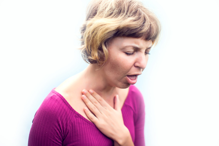 Throat Pain. Ill Woman Suffering From Painful Swallowing, Touching Neck With Hand. Female Caught Cold. Healthcare, people and medicine Concept.の写真素材