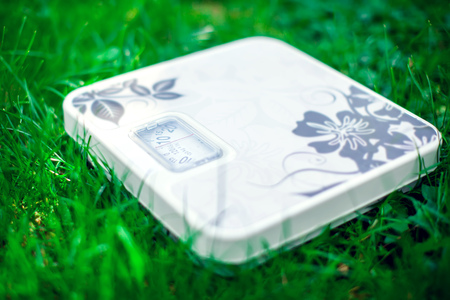 Lose weight concept. Scale on grass background outdoorの写真素材