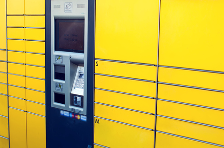 Self-service terminal for parcel post with yellow facade. Concept: delivery, self, easy.