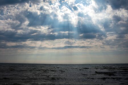 A sunset on the beach in summer. Sea and eveninig sky with cloudsの写真素材