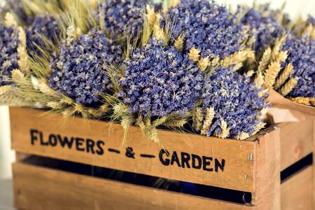 A lot of fresh purple wildflowers in wooden box for sell.の写真素材
