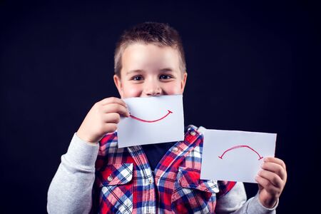Young teen select between positive and negative expressions. Children and emotions conceptの写真素材