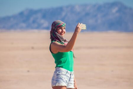 Woman makes selfie in the desert of Egypt. People and travel concept.の写真素材