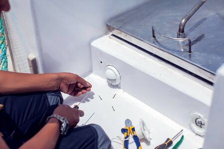 A man worker fix socket in the wall.