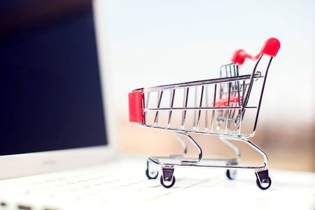 Laptop with shopping trolley. Online shopping and payment conceptの写真素材