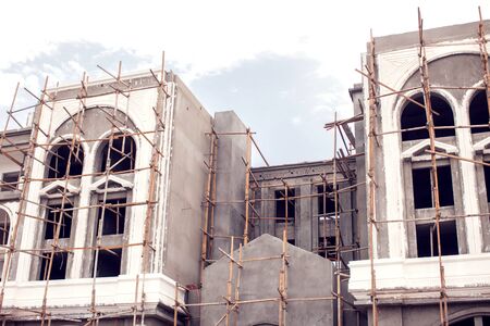 House with wooden scaffolding construction. Architecture and building concept.