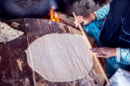 Arab woman makes bread in the beduin village in Egypt.