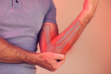 Man feels strong pain in elbow. People, healthcare and medicine concept
