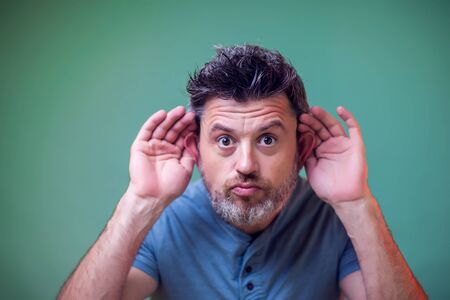 People and emotions - a portrait of man with beard overhear somethingの写真素材