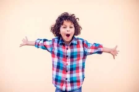 Little boy kid shows hugs with open arms