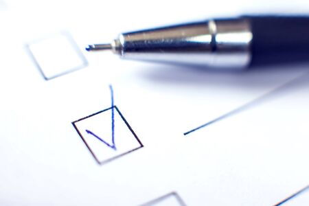 Checklist with a pen on white paper. Checkbox concept.