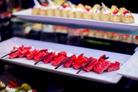 Close up delicious dessert pastry cakes in the hotel. Fresh colourful sweet berry desserts,...