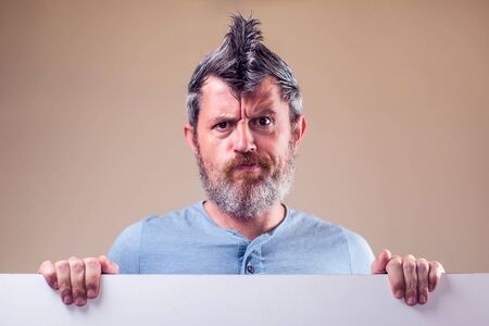 Closeup portrait of an adult man with a beard and iroquois. People and emotions conceptの写真素材