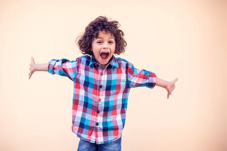 Little boy kid shows hugs with open armsの写真素材