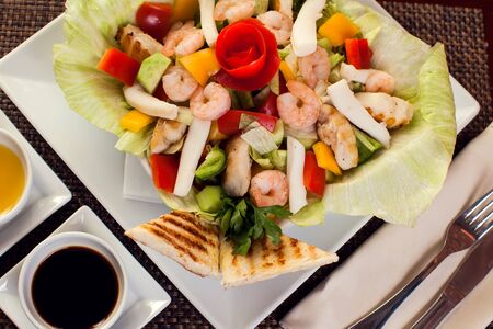 Sea food salad with sauces on white plate.の写真素材