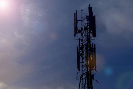 Cellular telecom pole high tower 3G 4G 5G , with blue sky and clouds backgroundの写真素材