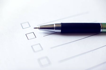Checklist with a pen on white paper. Checkbox concept.の写真素材