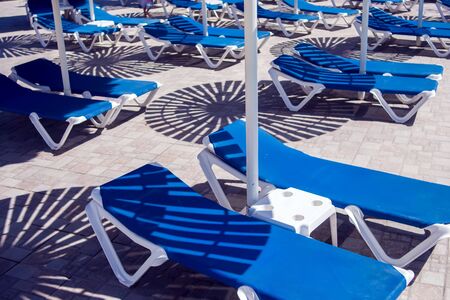 Beach chairs near swimming pool. Holiday and summer conceptの写真素材