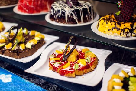 Dessert Sweets on banquet table. Rows of tasty looking desserts in beautiful arrangements hotel...