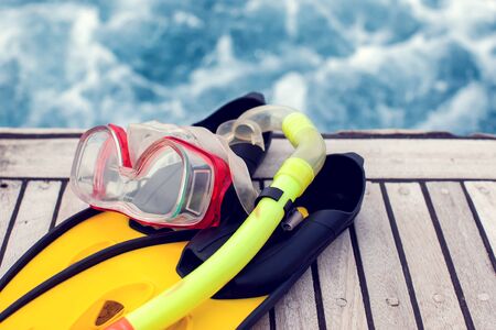 Summertime concept. Sea view. Diving mask and flippers lelft on boat.の写真素材