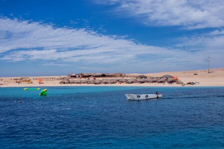 Mahmya island in red sea, Egypt, blue water, sky with clouds and boatsの写真素材