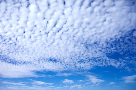 Blue sky background with a tiny clouds