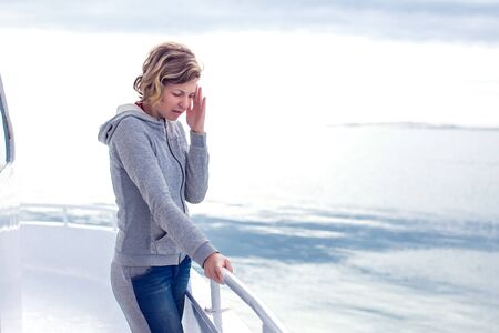 Cruise sea motion sickness young tourist woman. Seasick on boat vacation with headache. Fear of...