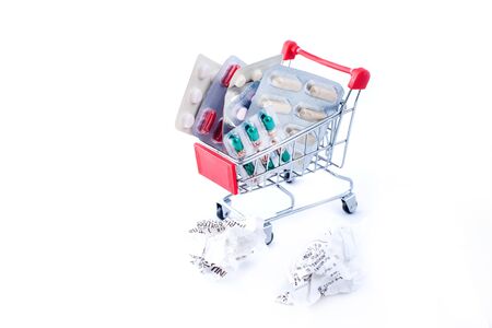 Full small shopping trolley of pills on white background. Health and medicine conceptの写真素材