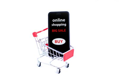 Shopping cart and sellphone. Isolated on white. Online shopping concept.の写真素材