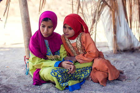 Egypt, Hurghada, 12 may 2019, two little girls sitting on the ground in the beduin village.のeditorial素材