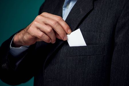 A portrait of bearded man in suit getting busuness card from the pocket. の写真素材