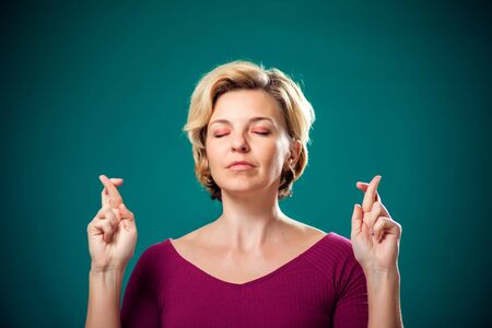 Woman with short blond hair hoping for good. People, lifestyle and emotions conceptの写真素材