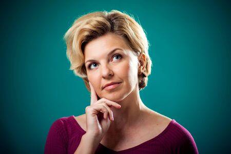 Woman with short blond hair thinking or dreaming. People, lifestyle and emotions conceptの写真素材