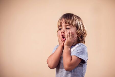 A portrait of surprised  kid boy. Children and emotions concept