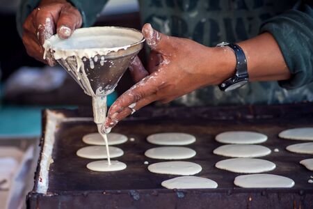 Man cooking tasty pancakes on the street in ramadan time. 
Arabic traditional cuisineの写真素材