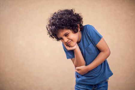 Kid boy feels strong tooth pain. Children, healthcare and medicine conceptの写真素材