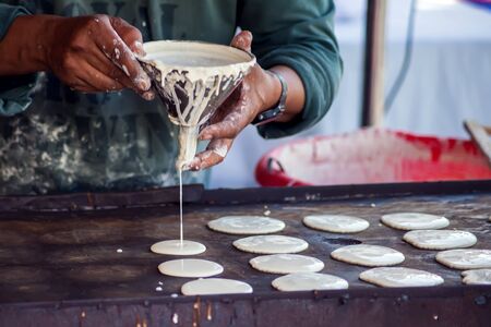 Man cooking tasty pancakes on the street in ramadan time. 
Arabic traditional cuisineの写真素材