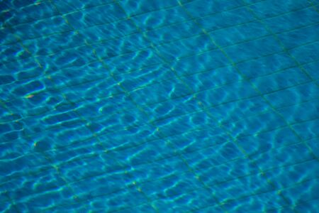 A backgroung view of blue water surface in the pool outdoor