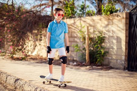 Kid boy with skateboard on the street. Childhood, leasure and lifestyle conceptの写真素材
