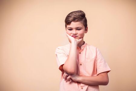 A portrait of unhappy kid boy. Children and emotions conceptの写真素材