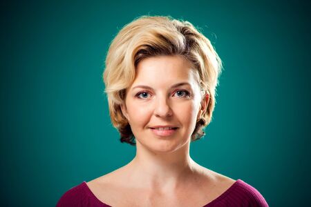 Smiling pretty woman with short blond hair looking at camera. People, lifestyle and emotions conceptの写真素材