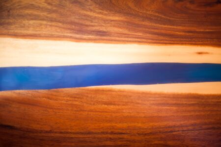 Treatment of wood with blue epoxy and varnish. manufacturing of furniture from solid