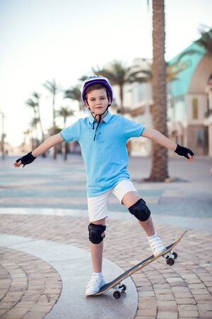 Kid boy with skateboard on the street. Childhood, leasure and lifestyle conceptの写真素材