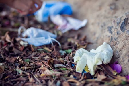 Used medical face masks and gloves on the street. Environmental pollution conceptの写真素材