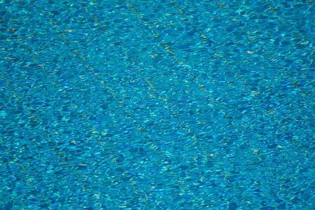 A backgroung view of blue water surface in the pool outdoorの写真素材